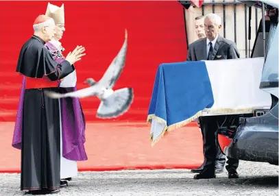  ?? PHOTO: REUTERS ?? The flagdraped coffin of former French president Jacques Chirac (pictured left) is seen in a hearse in front of the SaintSulpi­ce church after his funeral during a national day of mourning in Paris last month.