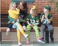  ?? MIKE DE SISTI / MILWAUKEE JOURNAL SENTINEL ?? Amanda Furman of Appleton waits for a stadium tour Monday at Lambeau Field with her children, Violet (from left), 3, Annah, 6, and Drew, 9. See more photos at jsonline.com/news.