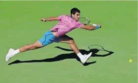  ?? | AFP ?? CARLOS Alcaraz, seen here stretching for a backhand against Fabian Marozsan, must first navigate a quarter-final against Alexander Zverev before any meeting with Jannik Sinner.