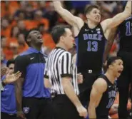  ?? NICK LISI - THE ASSOCIATED PRESS ?? Duke’s Zion Williamson, left, and teammates cheer after a Duke basket during the second half of an NCAA college basketball game against Syracuse in Syracuse, N.Y., Saturday, Feb. 23, 2019. Duke won 75-65.