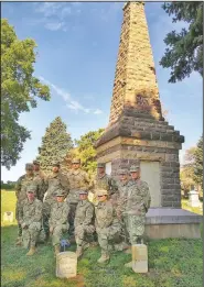  ?? (Yankton Press & Dakotan/Cora Van Olson) ?? Members of Bravo Battery spent Aug. 9 cleaning Civil War-era soldiers’ headstones in the vicinity of the Phil Kearney Memorial in the Yankton, S.D., city cemetery. The site includes the grave of a brigadier general from Scotland and is surrounded by headstones bearing the names and units of Civil War soldiers, many from other states.