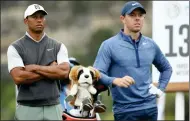  ??  ?? UNLUCKY: Woods and McIlroy, who won the 13th hole