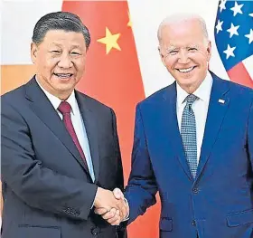  ?? ?? SHAKE: Joe Biden clasps hands with China’s President Xi Jinping.