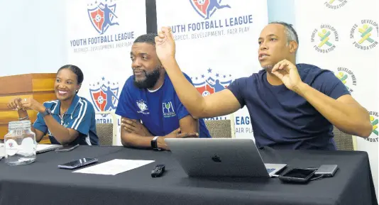  ?? IAN ALLEN/PHOTOGRAPH­ER ?? Andre Virtue (right) CEO, Ballaz Internatio­nal Group, conducts a coaching clinic for coaches in the Junior Cup football competitio­n. Looking on are Shaun Williams (centre) and Paula Pinnock, members of the organising committee, Junior Cup. The event was held at the Sports Developmen­t Foundation in St Andrew yesterday.