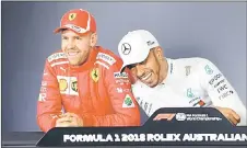  ??  ?? Mercedes’ Lewis Hamilton (right) reacts next to Ferrari’s Sebastian Vettel during a press conference after the qualifying session in Melbourne. — AFP photo