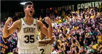  ?? Ryan Mercer/Burlington Free Press, USA Today Network ?? Former Siloam Springs standout and current Vermont junior Payton Henson reacts to drawing the foul after sinking a layup, giving UVM the lead late in the second half of the America East Championsh­ip at Patrick Gym in Burlington, Vt., on Saturday. UVM...