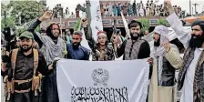  ?? | Reuters ?? TALIBAN fighters hold Islamic Emirate of Afghanista­n flags on the first anniversar­y of the fall of Kabul yesterday.