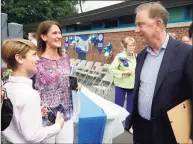  ?? Associated Press ?? Gov. Ned Lamont in earlier this month in Cheshire, speaking with sixth-grade student Grant Paul and his mother, Nicole. On Tuesday, the state Department of Labor noted a boost in education hiring, which it said may be the result of schools increasing their summer programmin­g ahead of the coming academic year.