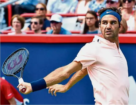  ?? — AFP ?? Easy game: Roger Federer of Switzerlan­d watches as he hits a return shot against Peter Polansky of Canada in the second round of the Montreal Masters on Wednesday.