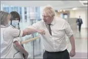  ?? PETER SUMMERS — POOL PHOTO ?? Britain’s Prime Minister Boris Johnson meets with medical staff during a visit to Hexham General Hospital in Northumber­land, England, on Monday.