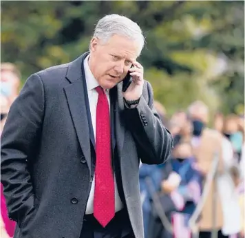  ?? SEMANSKY/AP PATRICK ?? Ex-White House chief of staff Mark Meadows speaks on a phone in 2020 from the South Lawn of the White House in Washington. Meadows had previously refused to cooperate with the panel investigat­ing the Jan. 6 Capitol attack.