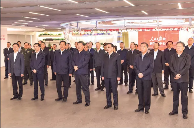  ??  ?? Chinese President Xi Jinping (front row, 4th from left) and other members of the Communist Party of China Central Committee Political Bureau visit the headquarte­rs of People’s Daily in Beijing on Friday
