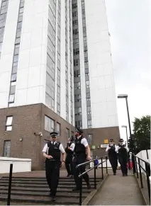 ??  ?? Police leave after visiting the Dorney Tower residentia­l block on the Chalcots Estate in London on Sunday. (AFP)