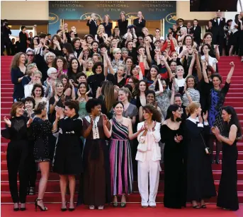  ??  ?? Below: directors, actresses and industry representa­tives on the red carpet in protest of the lack of female filmmakers honoured throughout the history of the festival. Right: authors of Noire n’est pas mon métier ( Black Is Not My Job) attend the screening of Burning.