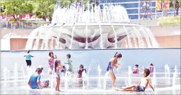  ??  ?? File photo shows children cooling off in the water play area at Grand Park in Los Angeles, California. — AFP photo