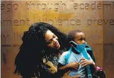  ?? SEBASTAIN HIDALGO NYT ?? Melody Boykin and her son Joseph, 2, at the YMCA in Chicago. After being furloughed, Boykin turned to the YMCA for food and supplies .