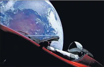  ?? AFP/Getty Images ?? THE RED Tesla — along with a dummy named “Starman” — launched on the Falcon Heavy rocket Tuesday.