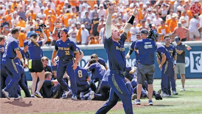  ?? RANDY SARTIN/AP ?? Notre Dame’s Jack Brannigan, who hit a tiebreakin­g home run in the seventh inning, waves to fans as teammates celebrate behind him after the Irish knocked off Tennessee on Sunday.