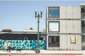  ?? Peter Prato / Special to The Chronicle ?? Arthur Mac’s Tap & Snack (with colorful wall) borders the shops and studios of MacArthur Annex, a creative enclave built from 33 refashione­d shipping containers in Oakland. The restaurant-beer garden co-hosts a monthly event at the annex called Second...