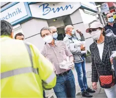  ?? RP-FOTO: ANDREAS BRETZ ?? Bezirksbür­germeister Uwe Wagner (M.) verteilt gemeinsam mit seinen Kollegen aus dem Gremium Masken an der Birkenstra­ße.