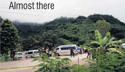  ?? PHOTO: REUTERS ?? Medivac ready . . . A group of ambulances travel to Tham Luang cave complex in the northern Thailand. Right: Thai Prime Minister Prayuth Chanocha poses with relatives of the trapped boys.