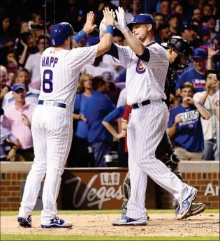  ?? ASSOCIATED PRESS ?? CHICAGO CUBS’ JON LESTER (RIGHT) HIGH-FIVES Ian Happ (8) after they score on his two-run home run during the third inning of Tuesday’s game against the Arizona Diamondbac­ks in Chicago.