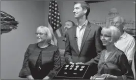  ?? The Associated Press ?? COTTON: U.S. Sen. Tom Cotton, R-Ark., takes questions from reporters after visiting with members of the George Anderson family and presenting them with medals Anderson won during World War II at a ceremony Wednesday in Little Rock. With Cotton are J.J. Walker of Sherwood, left, and Charlotte Garlington of Cabot, two of Anderson's daughters. Anderson, from Black Rock, died in 2006, according to the senator's office.