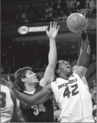  ?? AP/L.G. PATTERSON ?? Missouri’s Alex Oriakhi (42) grabs a rebound in front of Vanderbilt’s Shelby Moats (34) in the first half of the Tigers’ 81-59 victory Saturday in Columbia, Mo. Oriakhi had 18 points and a game-high 12 rebounds in the victory.