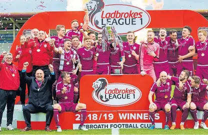  ?? Picture: SNS. ?? Arbroath players and management celebrate their League 1 title success.