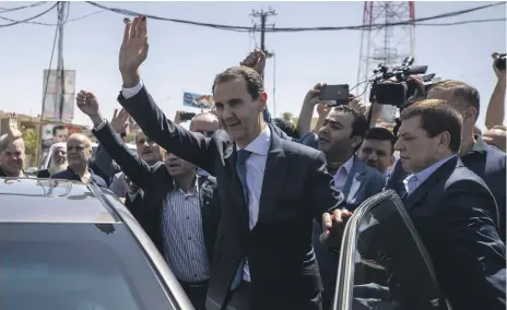  ?? AP ?? Syrian President Bashar Al Assad waves to supporters at a polling station during the presidenti­al elections in May