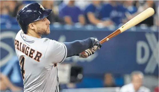  ?? Fred Thornhill / Canadian Press ?? Astros outfielder George Springer connects on his second home run of the night against the Blue Jays in the seventh inning. Springer was 4-for-4 with fiveRBIs.