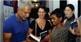  ??  ?? Signing books for his fans: Ashok Ferrey and right, and below, other invitees. Pix by Priyantha Wickramaar­achchi
