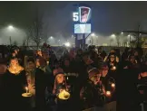  ?? JOSHUA BESSEX/AP ?? Bills fans and community members gather for a candleligh­t vigil for Bills safety Damar Hamlin on Tuesday in Orchard Park, N.Y.