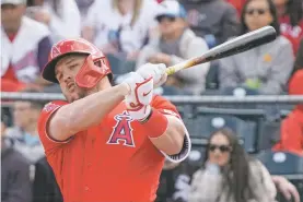  ?? MORRY GASH/ASSOCIATED PRESS FILE PHOTO ?? The Los Angeles Angels’ Mike Trout hits an RBI single during the second inning of a Feb. 26 spring training game against the Chicago White Sox in Tempe, Ariz.