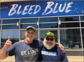  ?? JIM SALTER - THE ASSOCIATED PRESS ?? In this May 22, 2019 photo, longtime St. Louis Blues fans Stanley Jackson, left, and Steven Crow stand in front of the Enterprise Center in St. Louis, a day after the Blues defeated San Jose to earn a berth in the Stanley Cup Finals.