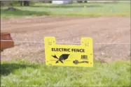  ?? PHOTOS BY LYNN KUTTER ENTERPRISE-LEADER ?? A solar electric fence is a new addition to the Lincoln Community Garden this year with hopes to keep out deer. The deer especially seem to like green beans and okra.