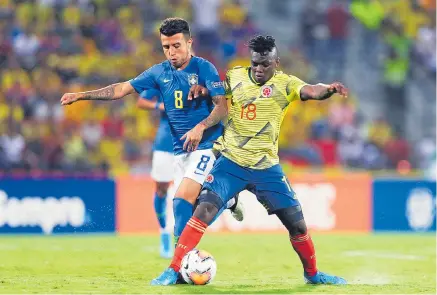  ?? AGENCIA EFE ?? Edwuin Cetré (d), autor del gol de la selección Colombia, busca sostener un balón frente a la marca de Matheus Henrique (i).