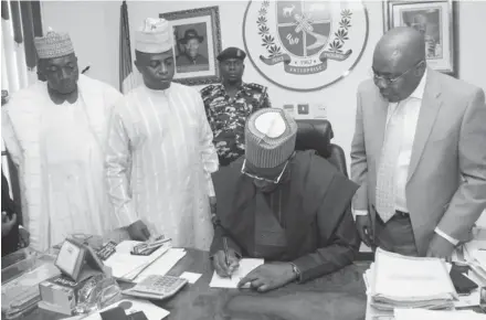  ?? PHOTO ?? From left, Deputy Speaker, Kwara State House of Assembly, Prof. Muhammed Gana Yisa; Speaker, Rasak Atunwa; Governor Abdulfatah Ahmed of Kwara and state Attorney -General and Commission­er for Justice, Barrister Kamaldeen Ajibade, during the signing of...