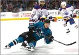  ?? Associated Press ?? San Jose Sharks right wing Marcus Sorensen trips as he chases the puck against Edmonton Oilers defenseman Darnell Nurse during Saturday’s playoff game in San Jose.