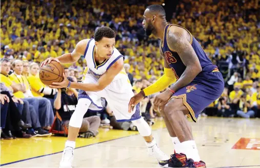  ??  ?? Golden State Warriors guard Stephen Curry, left, is guarded by Cleveland Cavaliers forward LeBron James during the second half of Game 5 of basketball's NBA Finals in Oakland, Calif. in this June 24, 2015 photo. (AP)