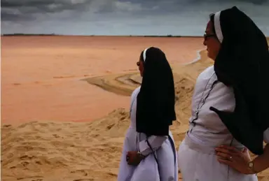  ?? MARCIO PIMENTA PHOTOS FOR GLOBALPOST ?? Nuns observe the Doce River, one of the largest in Brazil, polluted with mining waste, in Regencia.