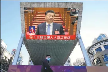  ?? Ng Han Guan Associated Press ?? A NEW wave of COVID-19 outbreaks has upended Chinese President Xi Jinping’s zero-tolerance approach to the virus, which includes harsh lockdowns. Above, Xi is seen on a live broadcast at a mall in Beijing in March.