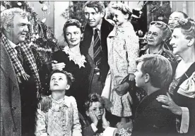  ?? AP ?? George Bailey (Jimmy Stewart), center, holds Zuzu (6-year-old Karolyn Grimes), in the 1946 Frank Capra classic “It’s a Wonderful Life.”