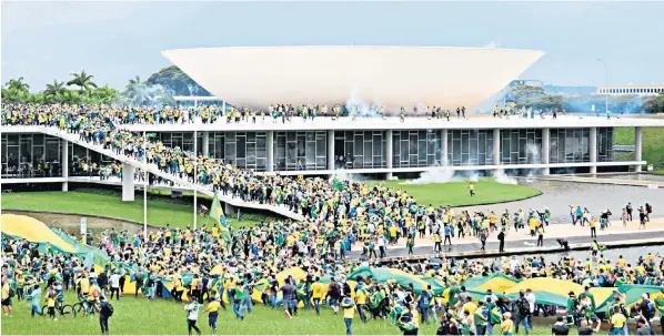  ?? ?? Supporters of Jair Bolsonaro demonstrat­e yesterday at the Esplanada dos Ministerio­s in Brasilia. The scenes, and later invasion of Brasil’s congress, echoed actions by Trump followers in Washington on Jan 6 last year