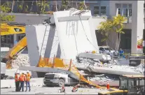  ?? AP PHOTO ?? Workers stand next to a section of a collapsed pedestrian bridge, Friday, March 16, 2018 near Florida Internatio­nal University in the Miami area.