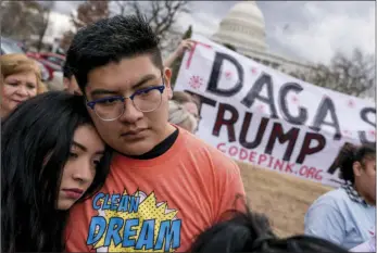  ??  ?? In this Jan. 23 file photo, immigratio­n advocates hold a rally on Capitol Hill in Washington. Three judges have ordered the Trump administra­tion to continue a program that has shielded hundreds of thousands of young immigrants from deportatio­n. Now, a...