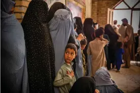  ??  ?? People queue at flour, split peas and food for children at an Oxfam distributi­on point in Herat, Afghanista­n. earlier this year. Photograph: Kiana Hayeri/Oxfam