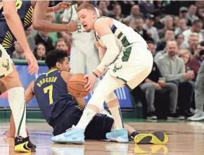  ?? RICK WOOD / MLWAUKEE JOURNAL SENTINEL ?? Bucks guard Donte DiVincenzo takes the ball from Pacers guard and former Buck Malcolm Brogdon Wednesday night.