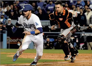  ?? DAVID CRANE — SOUTHERN CALIFORNIA NEWS GROUP ?? Giants catcher Buster Posey of the Giants runs down Gavin Lux of the Dodgers in a pickle between home and third base during the fifth inning of Game 4 of the National League Division Series at Dodger Stadium on Tuesday night.