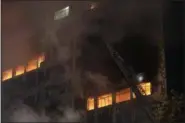  ?? ANDRE PENNER — THE ASSOCIATED PRESS ?? Firefighte­rs work to douse the flames, in a building next to another one that caught fire and collapsed in Sao Paulo, Brazil, Tuesday.